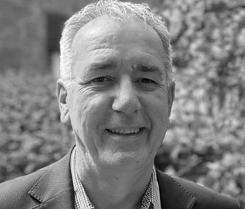 Jonathan Cage, senior consultant at Create Consulting Engineers, professional portrait photograph in black and white outdoors.