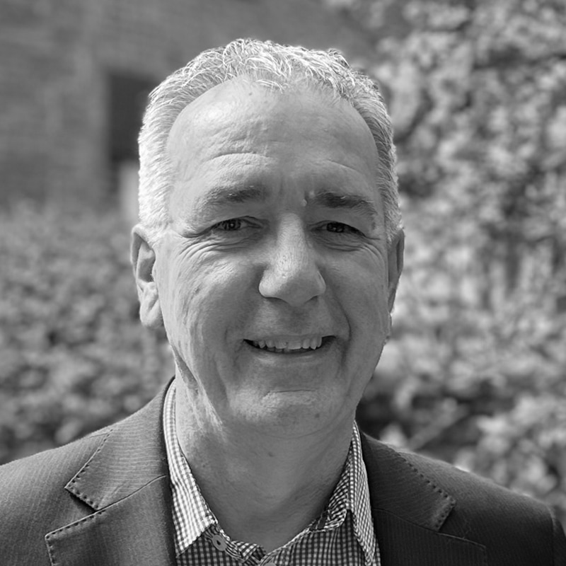 Jonathan Cage, senior consultant at Create Consulting Engineers, professional portrait photograph in black and white outdoors.