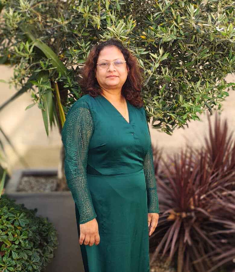 Create Consulting Engineers staff member in professional portrait outdoors amongst garden landscaping and vegetation.
