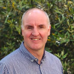 Barrie Anderson, Chartered Engineer and Regional Director at Create Consulting Engineers, wearing a blue checked shirt outdoors.