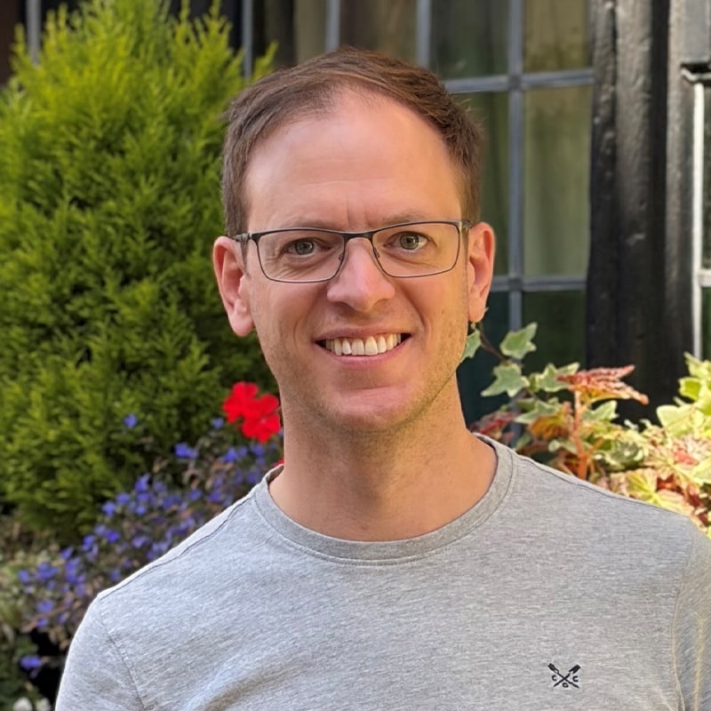 Tom Bennett, Principal Geotechnical Engineer at Create Consulting Engineers, smiling outdoors in casual attire.