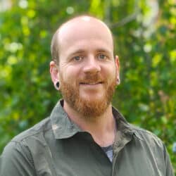 James Everitt, consulting engineer at Create Consulting Engineers, pictured outdoors against green foliage backdrop.