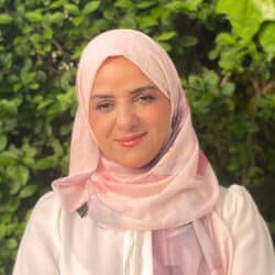 Dr Tara Rasoul, consulting engineer at Create Consulting Engineers, pictured against green foliage backdrop wearing pink hijab.