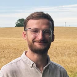 Martyn Broom, Acoustic Consultant at Create Consulting Engineers Norwich office, standing in a wheat field.