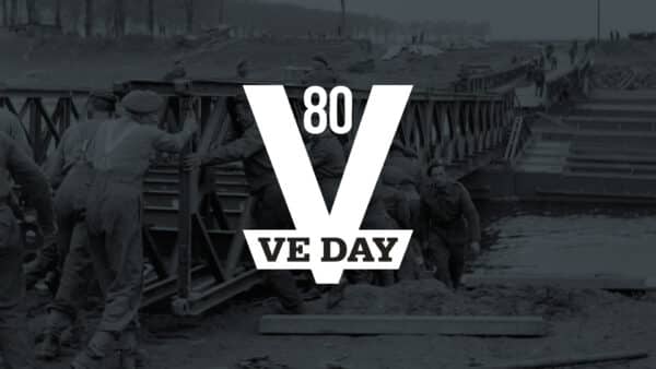 Soldiers build a bridge over water with "80 VE DAY" text overlay, commemorating the 80th anniversary of Victory in Europe Day during World War II.