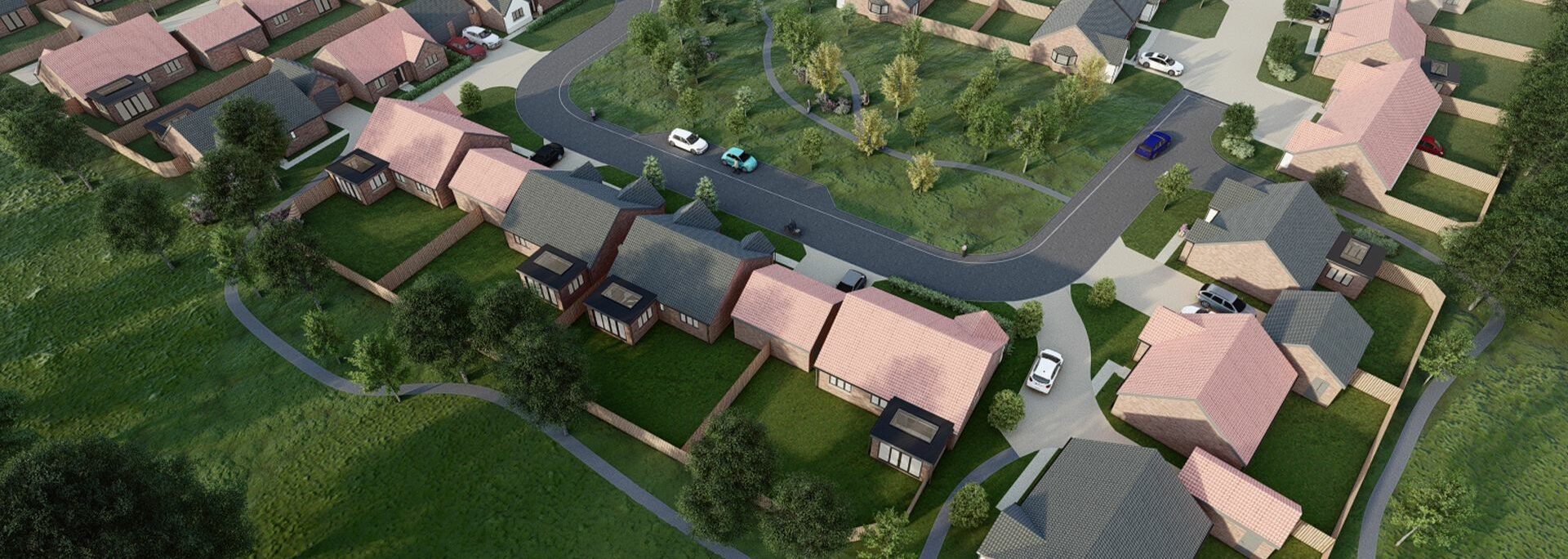 Aerial view of a suburban housing development with single-story homes, driveways, roads, green lawns, and trees, surrounded by open grassy areas.