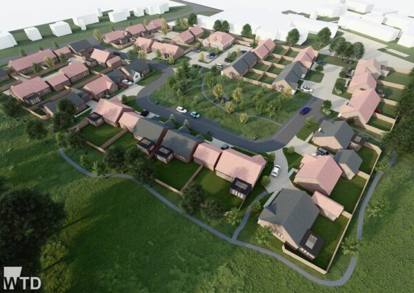 Aerial view of a suburban housing development with single-story homes, driveways, roads, green lawns, and trees, surrounded by open grassy areas.