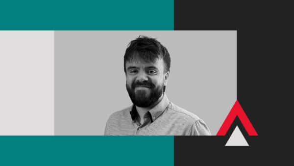 Sam Ward, a man with a beard and short hair, smiles against a gray background, surrounded by geometric shapes in teal, black, white, and red.