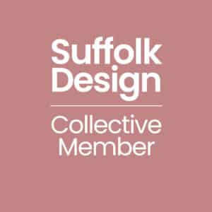 White text on a muted pink background reads "Suffolk Design Collective Member" with a horizontal line separating the top and bottom lines.