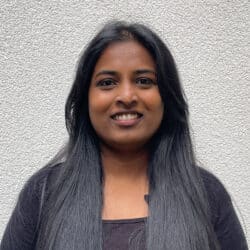 Rethu Rathinam, engineering consultant at Create Consulting Engineers, smiling at camera against neutral background.