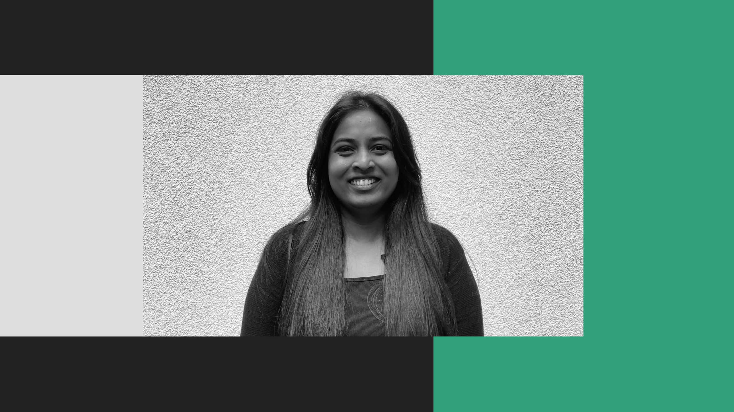 A woman with long hair stands in front of a textured wall, smiling at the camera. The image features Retb-inspired black, white, and green graphic borders.