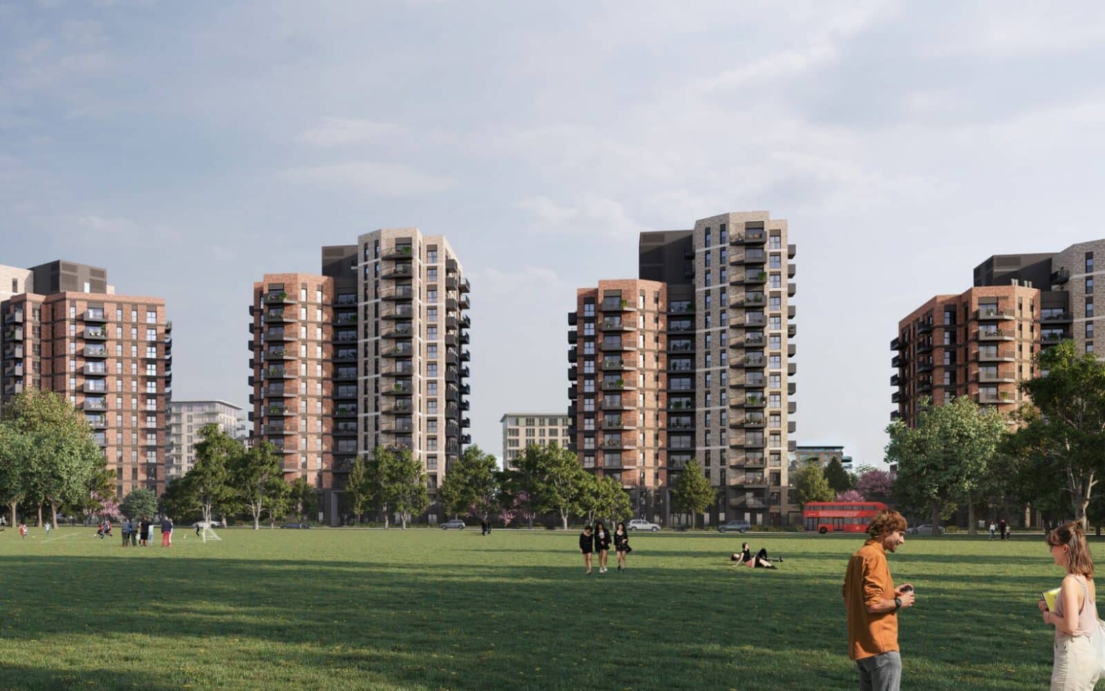 Several mid-rise blocks of flats border a large green park where people are walking, sitting, and talking; trees line the park under a partly cloudy sky.