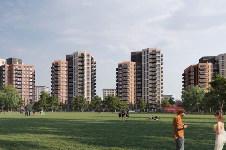 Several mid-rise blocks of flats border a large green park where people are walking, sitting, and talking; trees line the park under a partly cloudy sky.